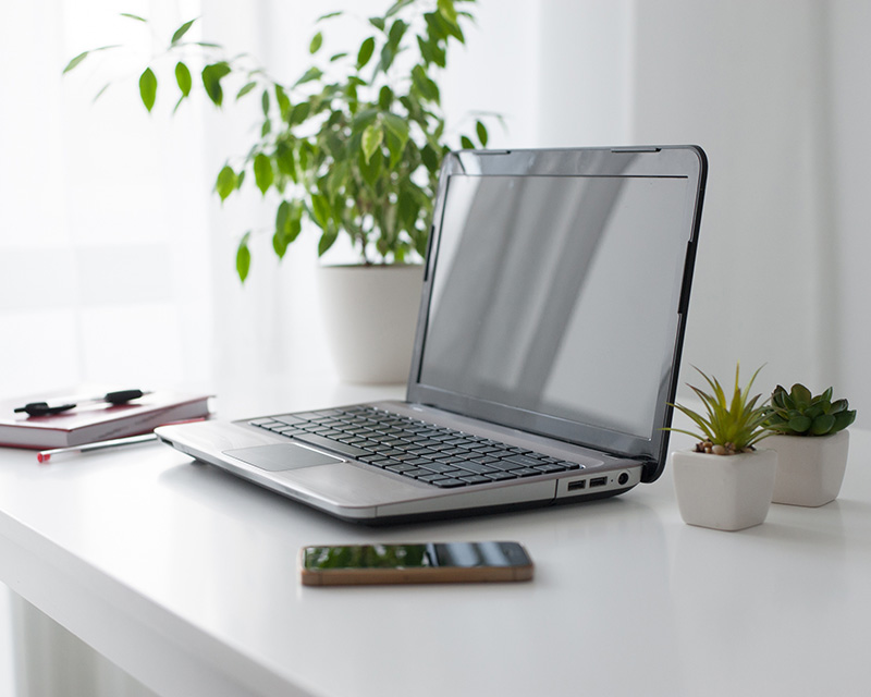 Laptop on a desk prepared for intake in initial therapy session