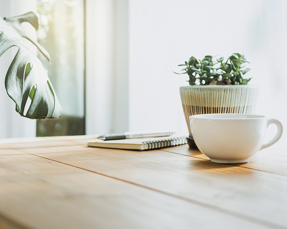 Mug of tea and small plant on desk for Irvine therapist, Jennifer Overley, LCSW