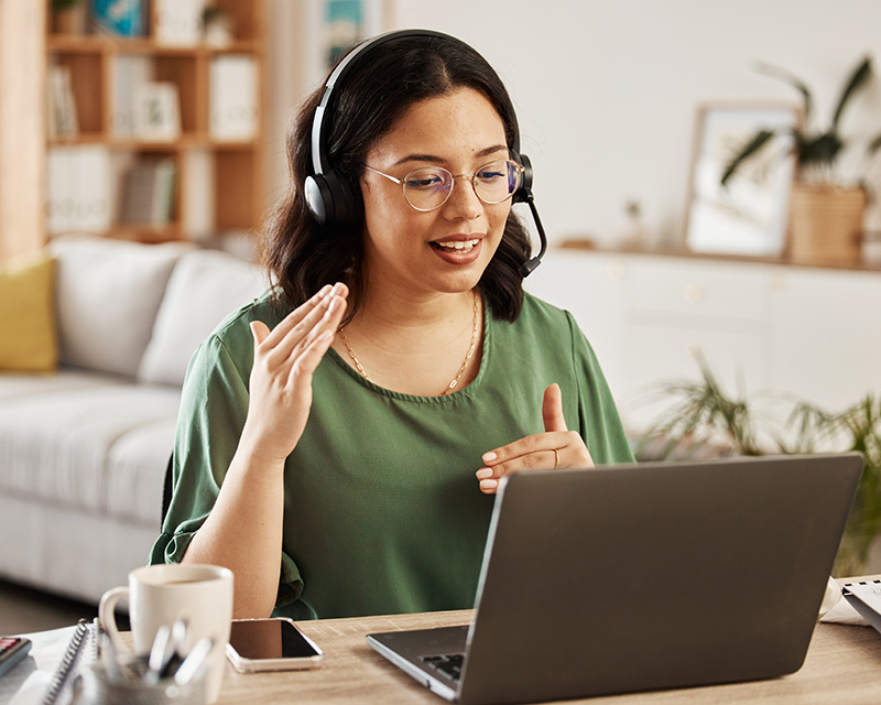 Multi-cultural woman at a laptop having online therapy addressing women's issues